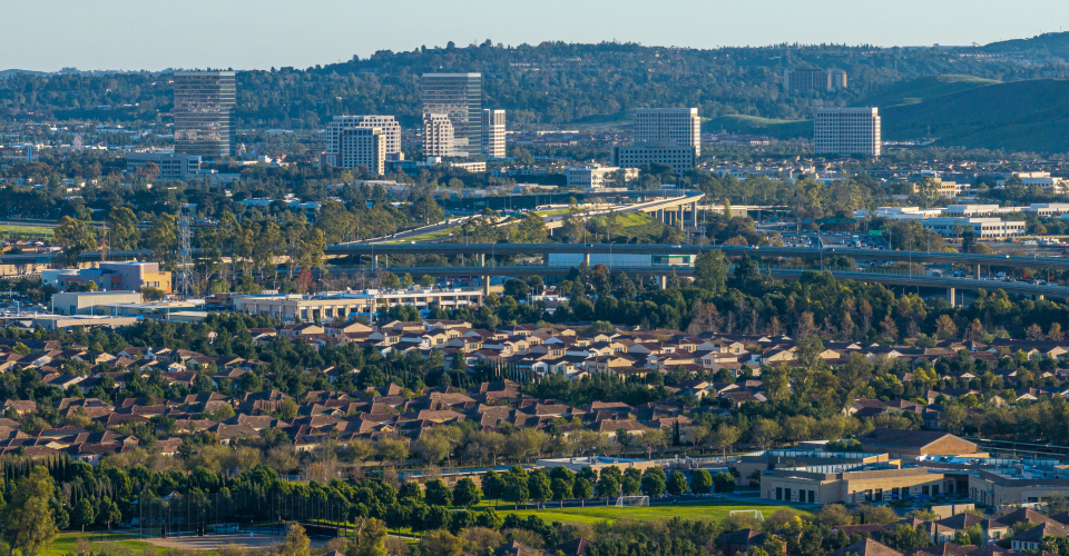 Photo of suburban landscape featuring houses, high rises and hills