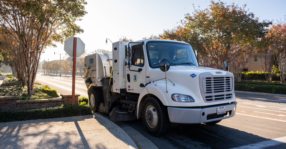 Street sweeper on a street at a stop sign