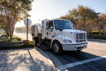 Street sweeper on a street at a stop sign