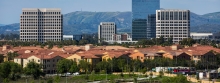 houses and office buildings with mountains in the background